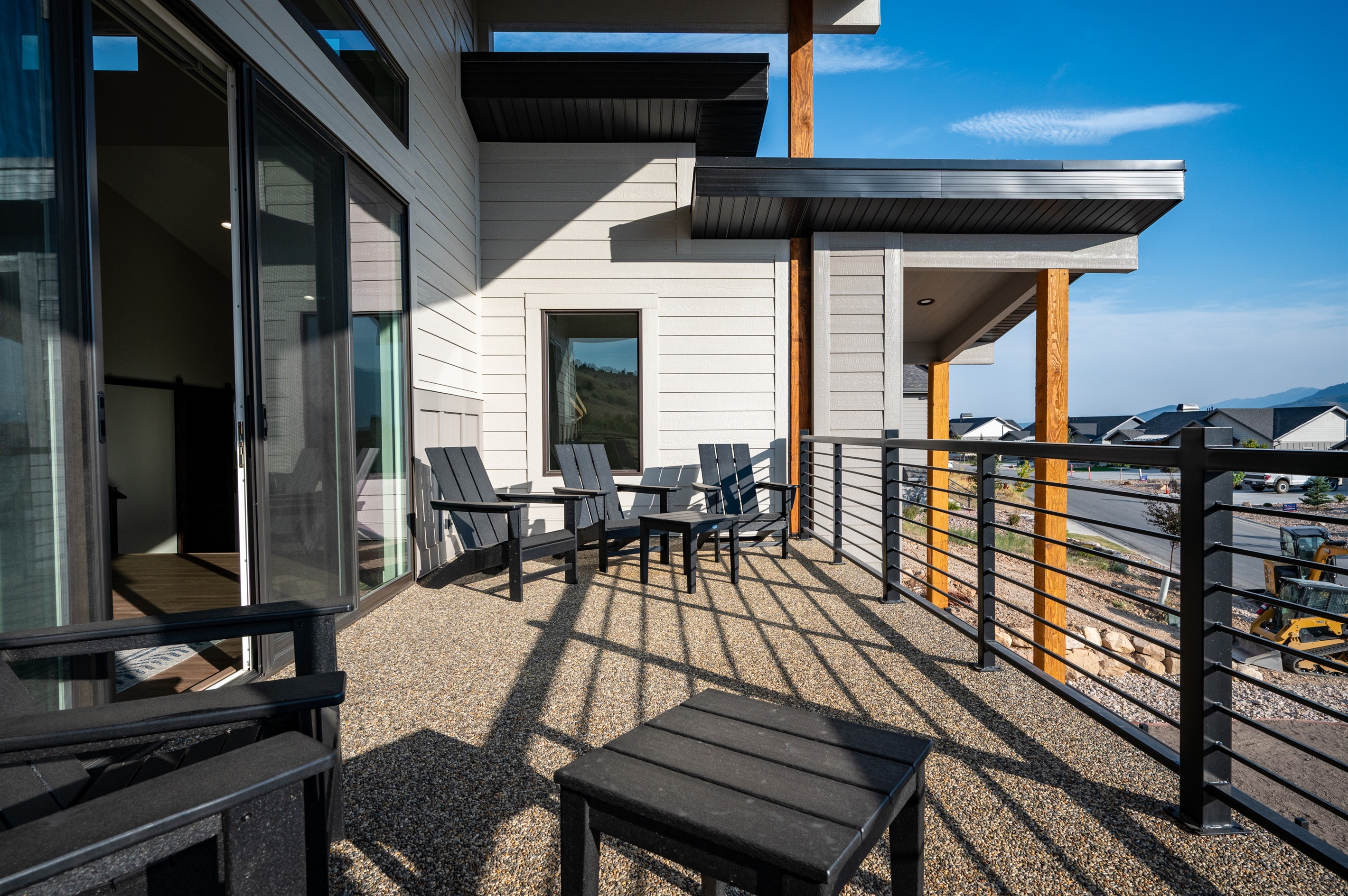 The deck offers comfortable seating for guests along with tables—perfect for outdoor dining or morning coffee with a view.