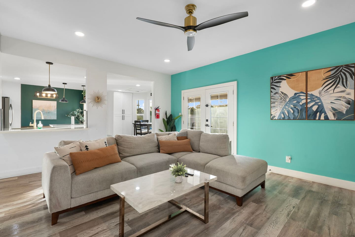 Open living space with vibrant turquoise accent wall.
