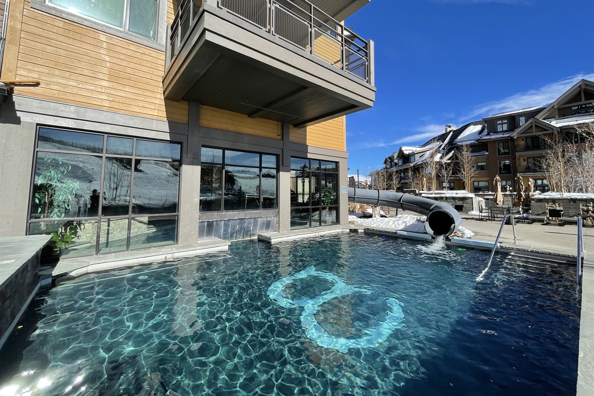 Outdoor heated pool with slide