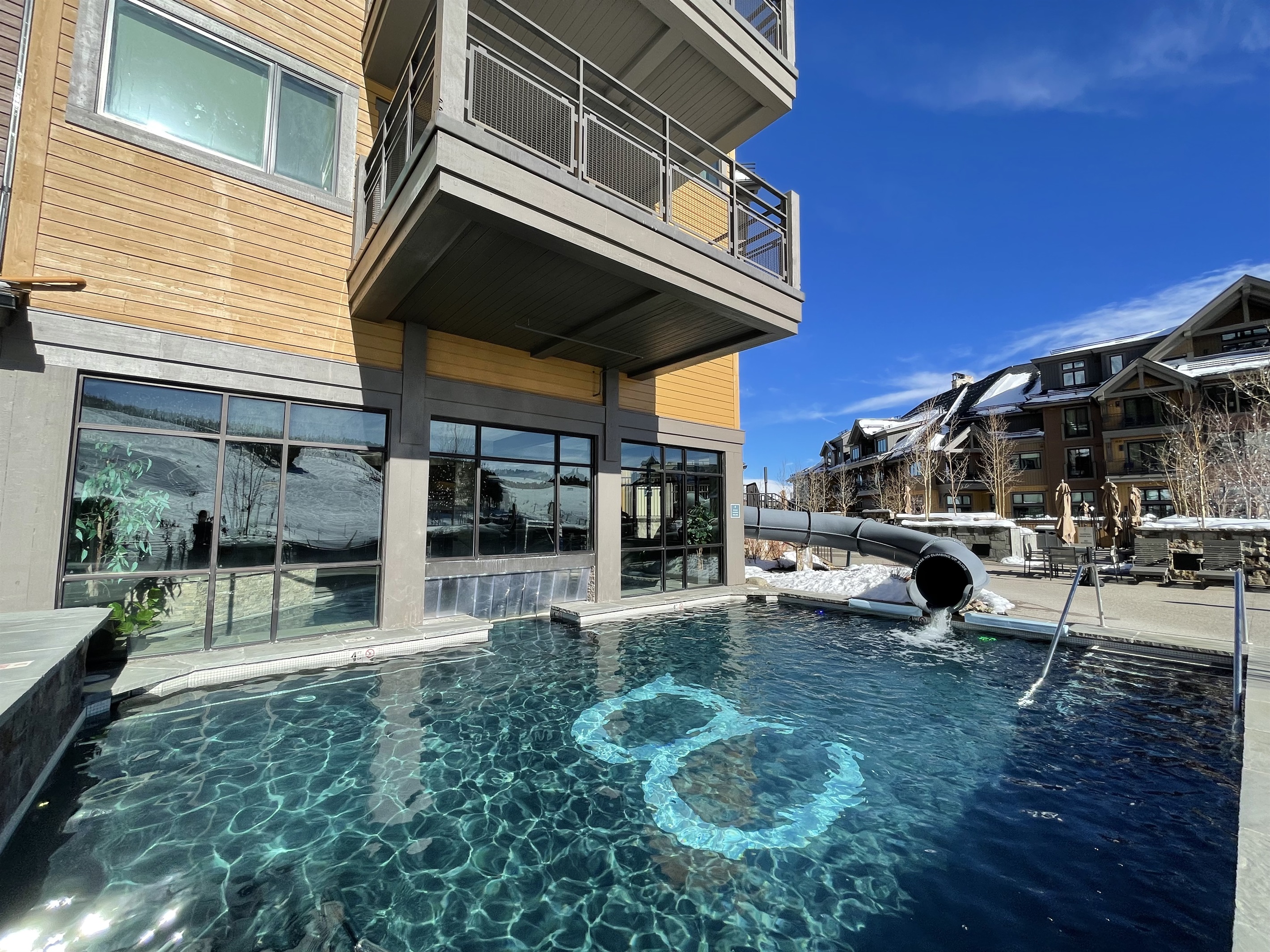 Outdoor heated pool with slide