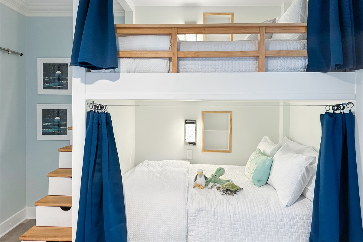 This room has built-in double bunk beds with blackout curtains for added privacy and sleeping comfort.
