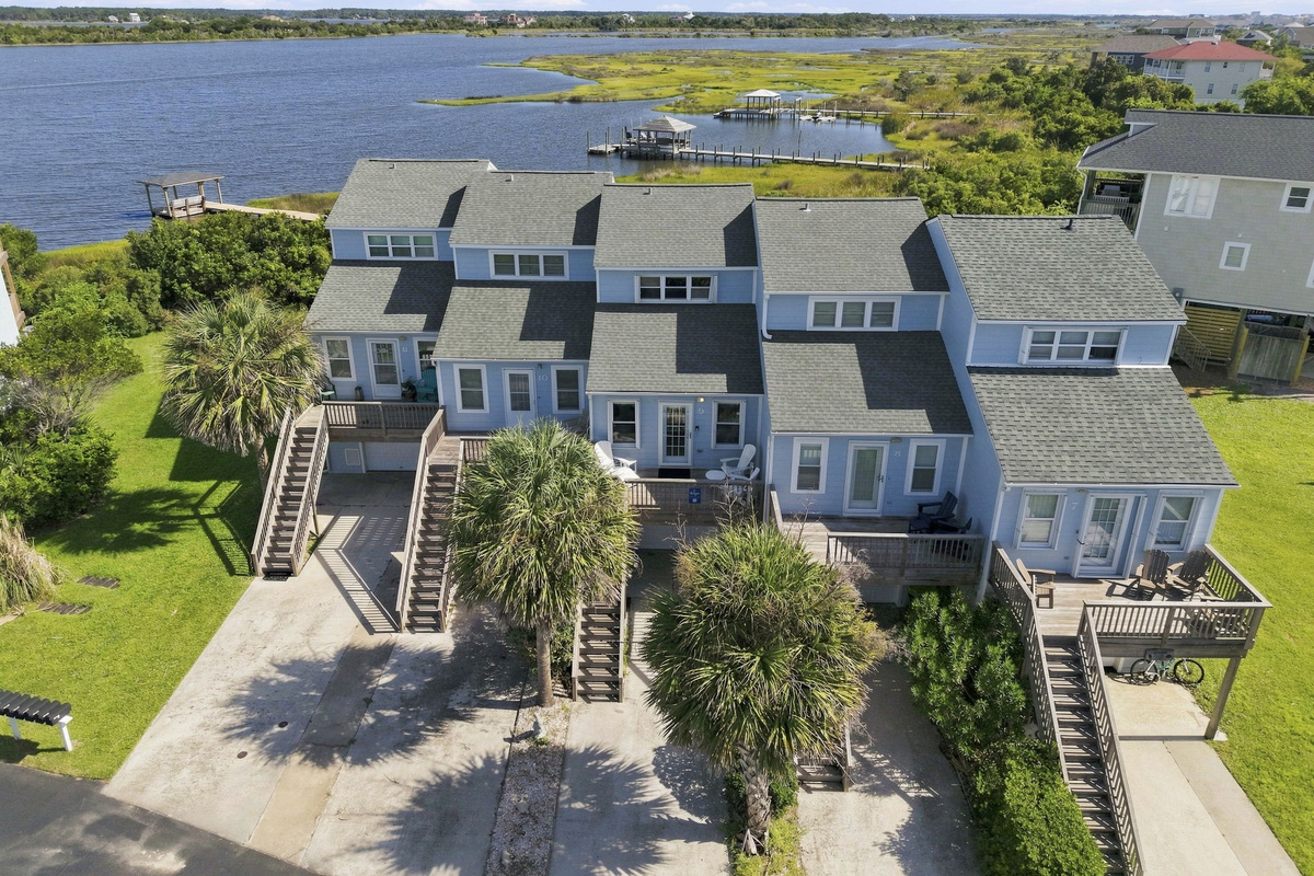 A breathtaking bird's-eye view showcasing the beautiful waterfront setting and charming townhome layout.