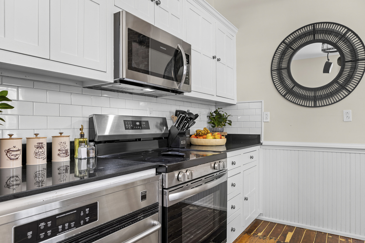 White subway tile, a stainless range, and all the cookware you need for a proper group meal.