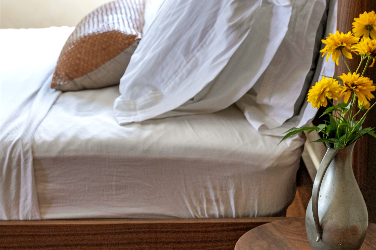This queen-size bedroom was designed with both comfort and function in mind. Soft linens invite you to unwind, while bedside tables add convenience and thoughtful detail.
