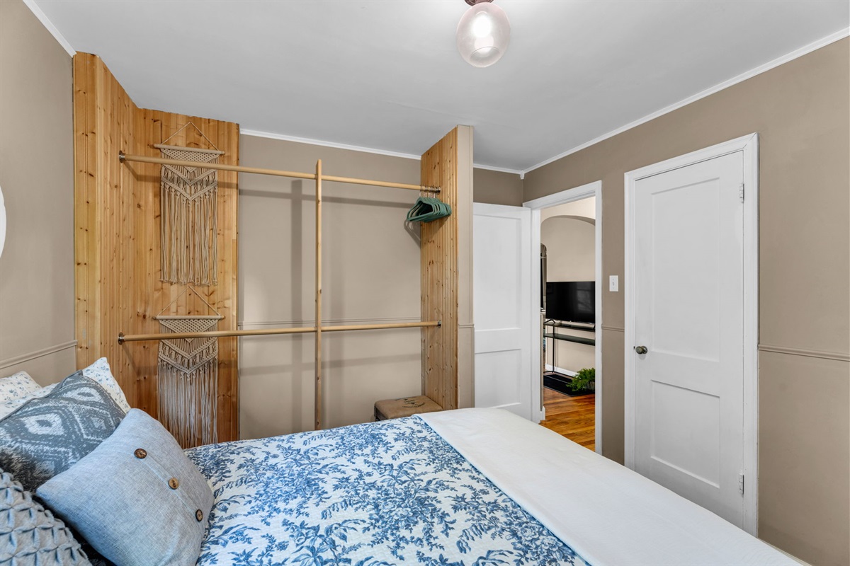 Another view of our first bedroom, showing a space where you can hang your clothes.