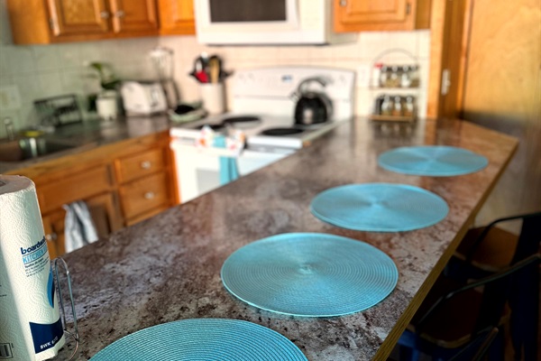 Kitchen bar seating (4 stools) — an easy spot for coffee, quick breakfasts, and kid-approved snacking at Grey Haven.  