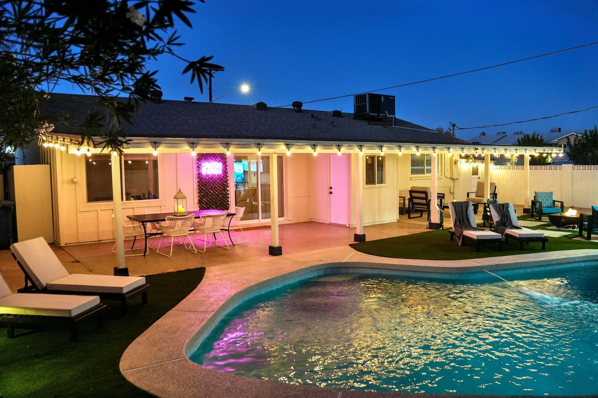 As the sun sets, the backyard comes to life with soft and inviting lights to dine, swim, or play under the Arizona sky.