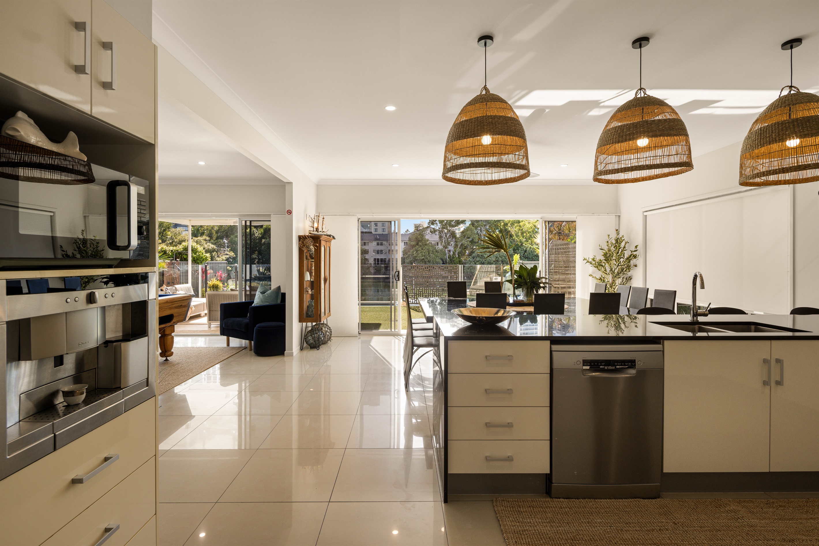 Seamless indoor flow between designer kitchen, dining and relaxed lounge spaces.