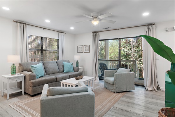 Welcoming Living Room: Step into comfort with our spacious living room, featuring plush seating and modern décor, perfect for relaxation after a sunny day at the beach.