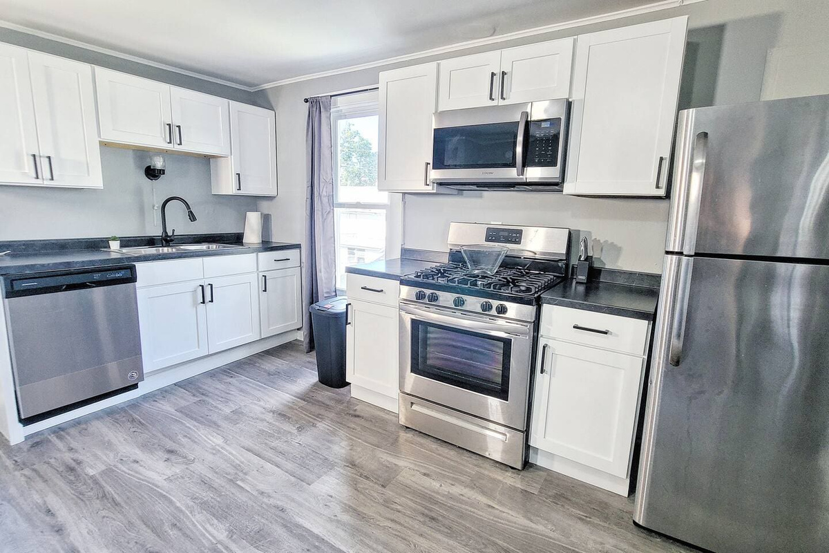 Modern full kitchen featuring sleek stainless steel appliances, ample counter space, and all the essentials for a seamless cooking experience.