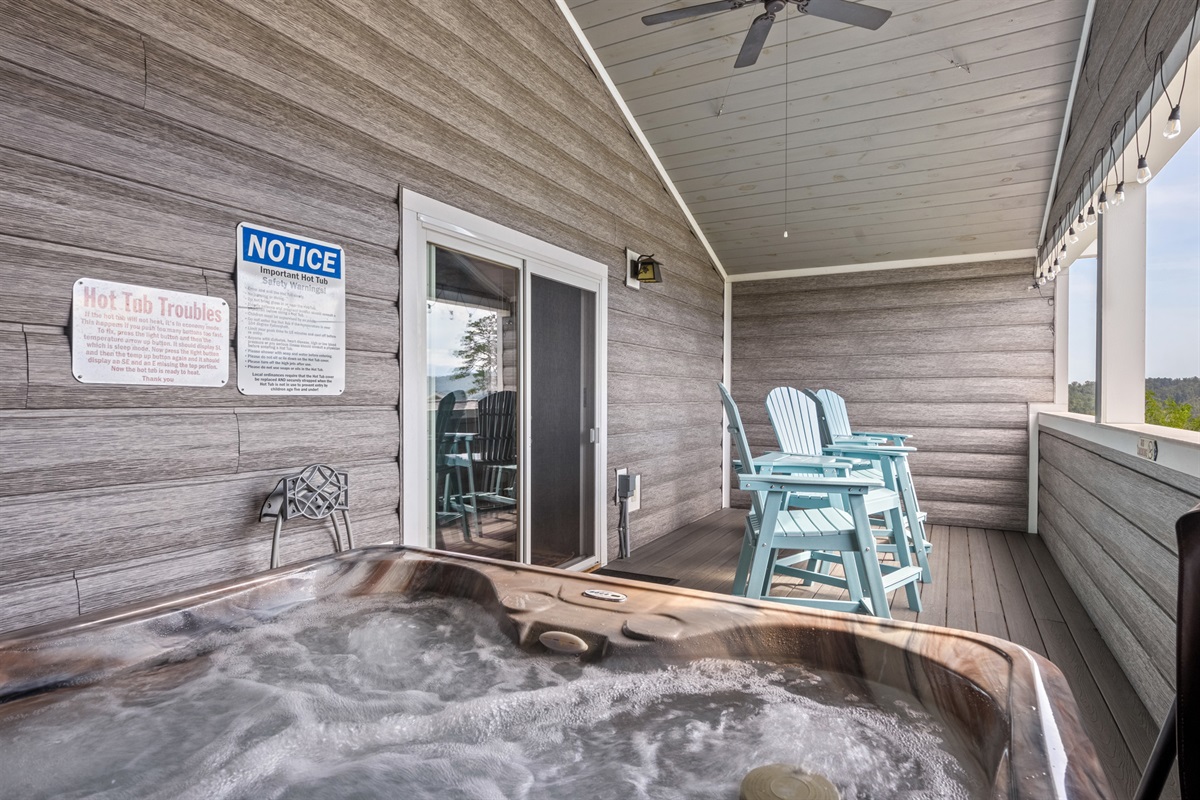 Enjoy the tranquility of hot tub or grab a seat in 1 of the settee chairs while relaxing on the covered deck.