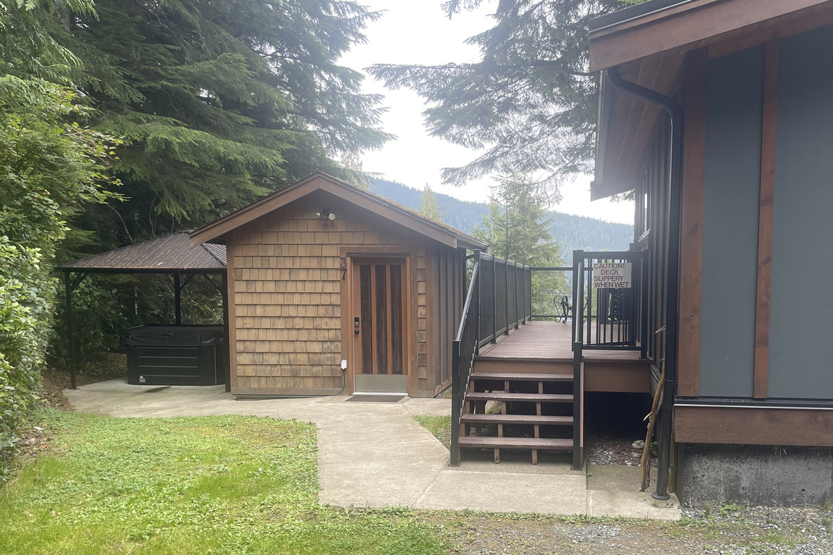 The covered Hot Tub, Bunkhouse, and stairs to the Deck and Cottage entrance