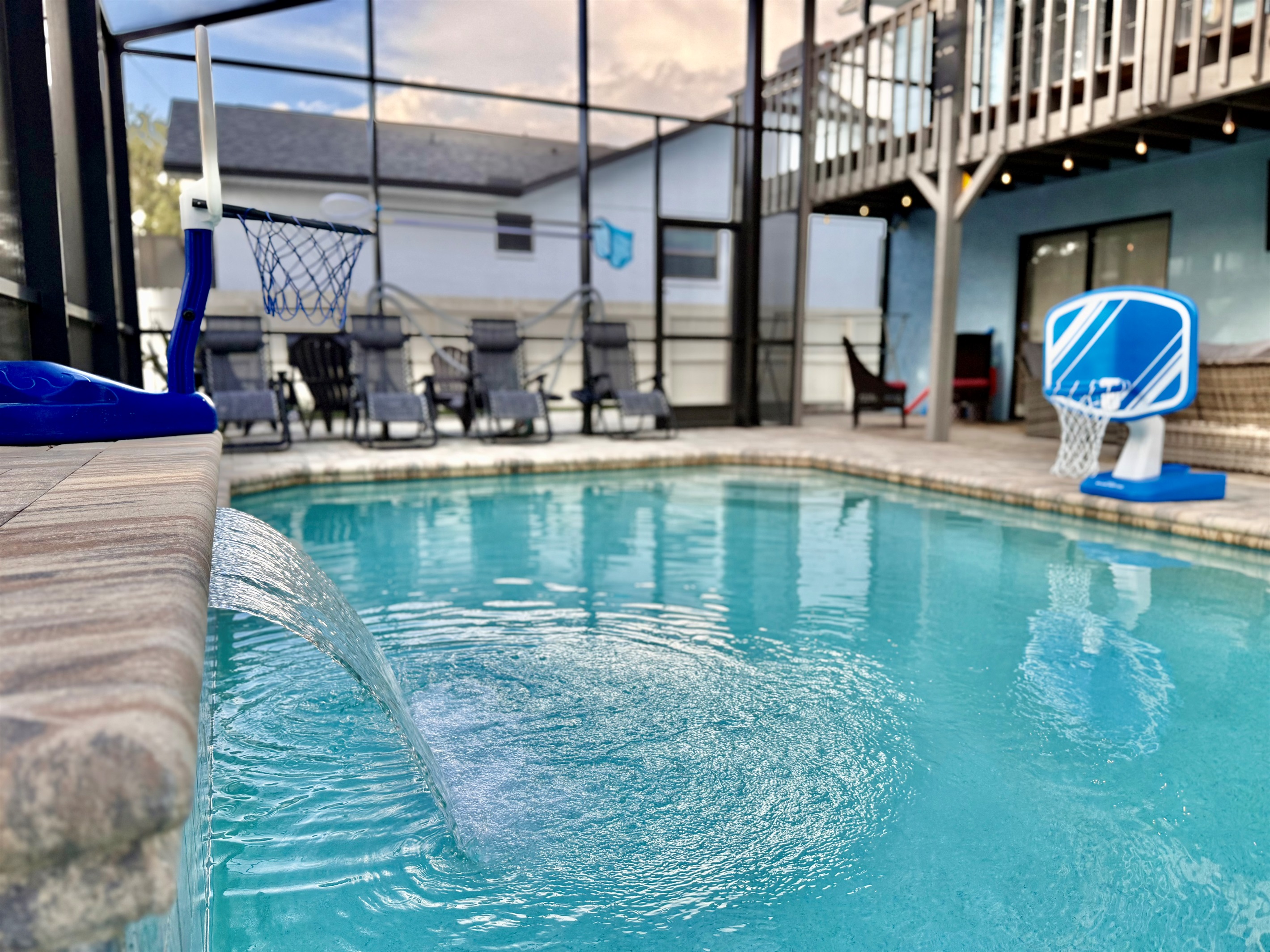 Take a dip in the crystal-clear waters of this inviting pool, framed by elegant paver decking and highlighted by a soothing cascading waterfall.