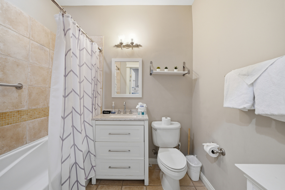 Our full-size bath has a tiled shower/tub combo.