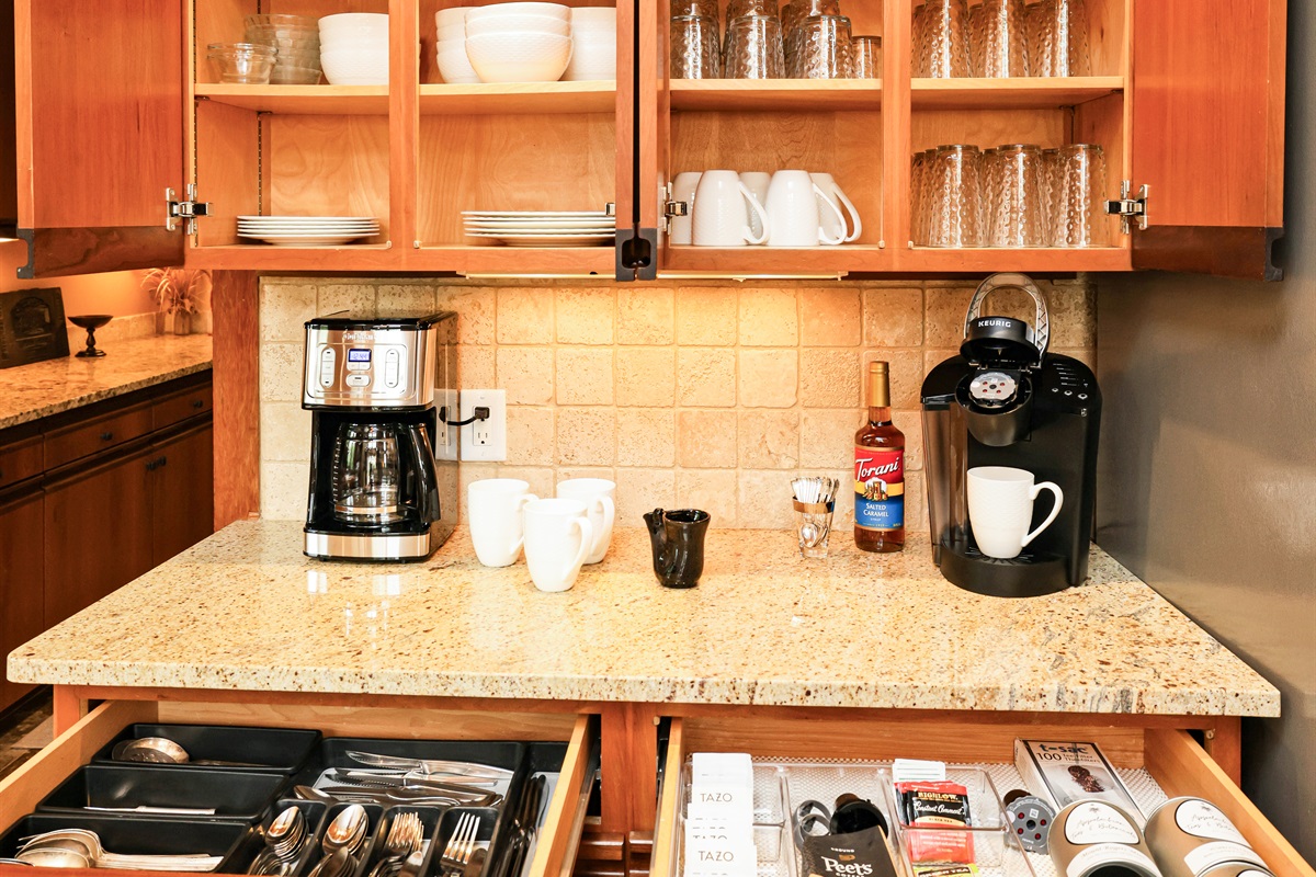 Coffee and tea bar area with a drawer of tea selections and sweeteners plus Peets Coffee to start out your stay!  Dishes are stored above with 16 place settings (they are set up on dining table when this photo was taken!)