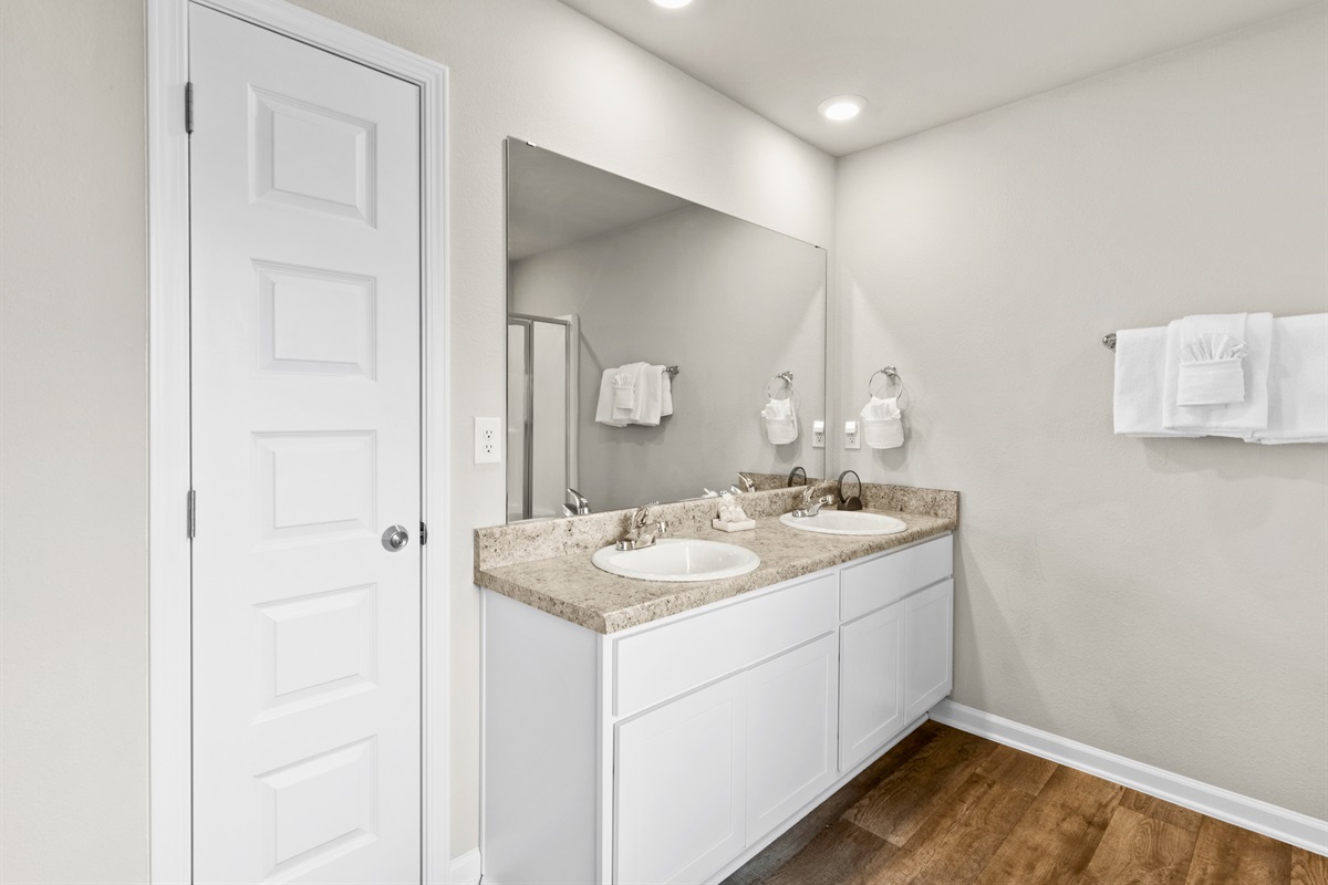 Bright vanity with double sinks makes mornings a breeze for couples or families.