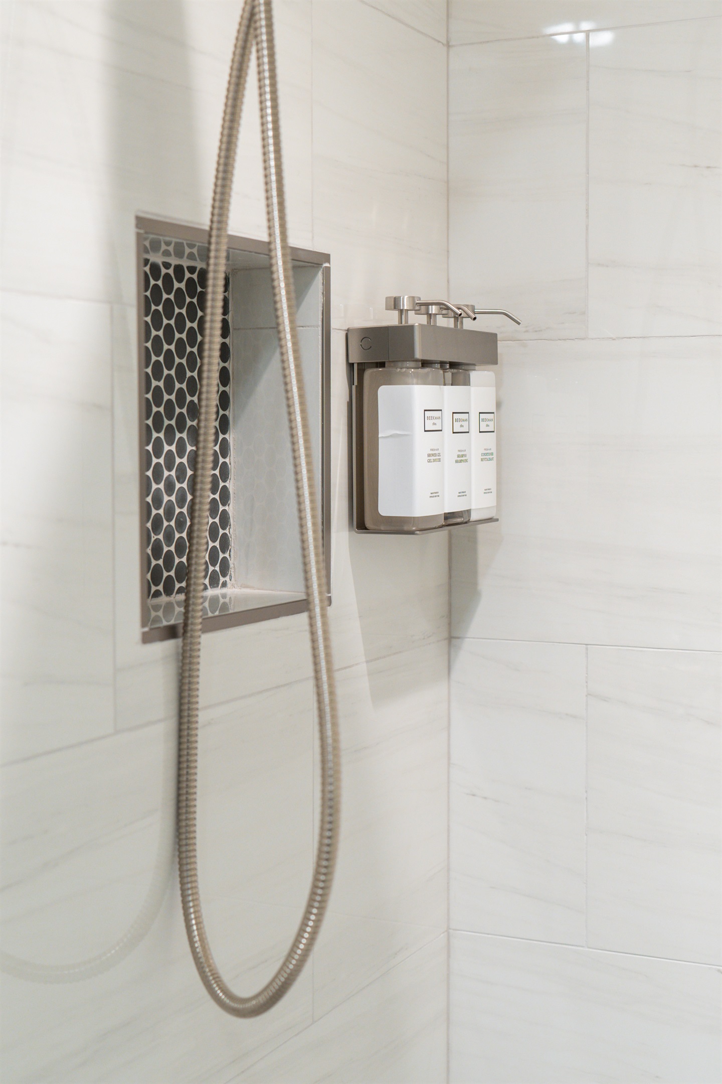 Detachable hand shower and luxury Beekman 1802 Fresh Air shampoo, conditioner  and body wash, in the full bathrooms on the lower level.