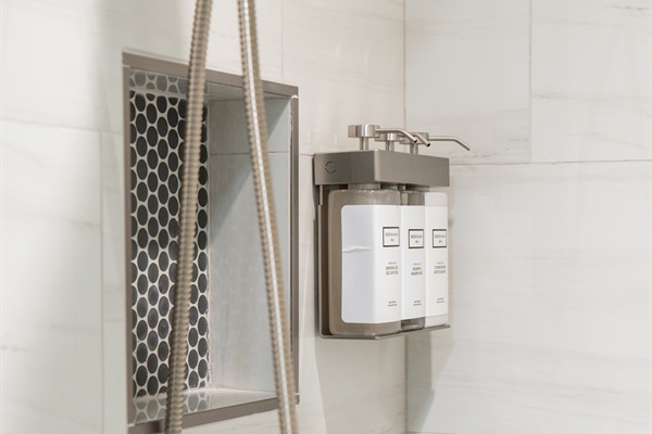 Detachable hand shower and luxury Beekman 1802 Fresh Air shampoo, conditioner  and body wash, in the full bathrooms on the lower level.