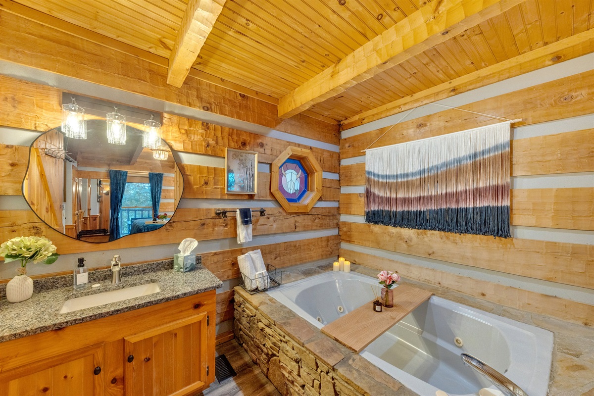 Spacious bathroom with double jetted tub and rustic cabin touches