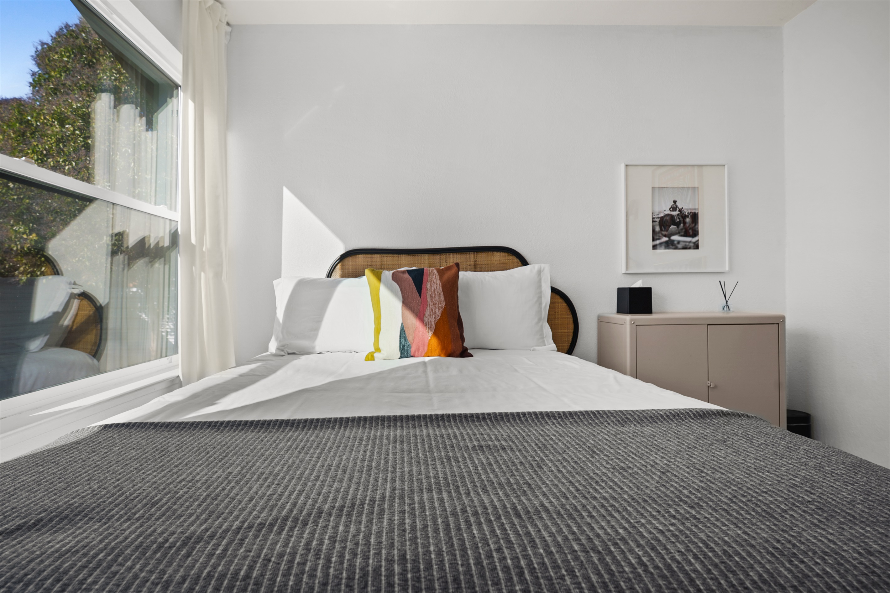 Inviting guest bedroom with a cozy queen bed, soft linens, and a peaceful atmosphere for a restful night's sleep.