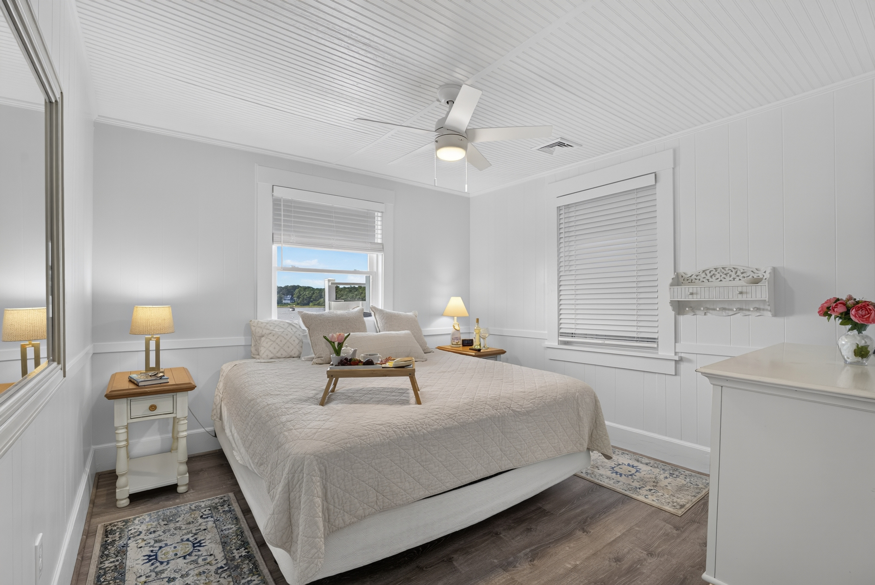Peaceful primary bedroom featuring a plush king-size bed, soft lighting, and a relaxing ambiance.