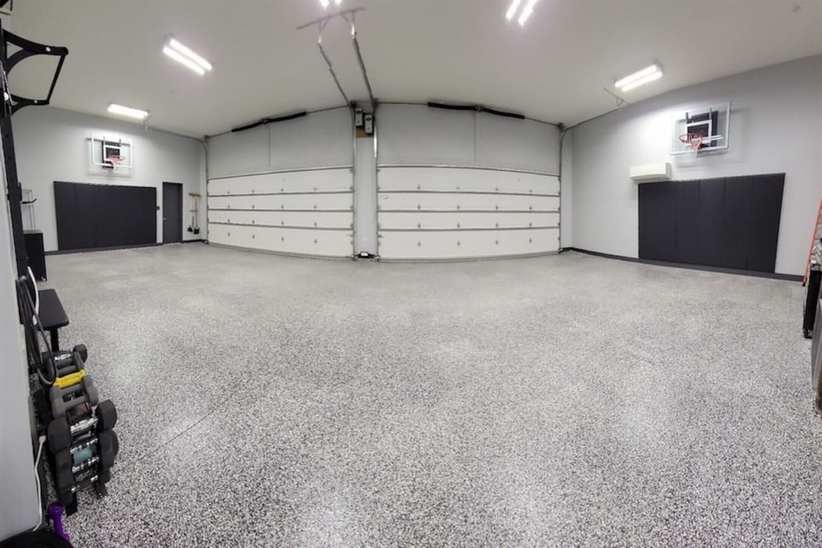 Garage with gym equipment and basketball hoops