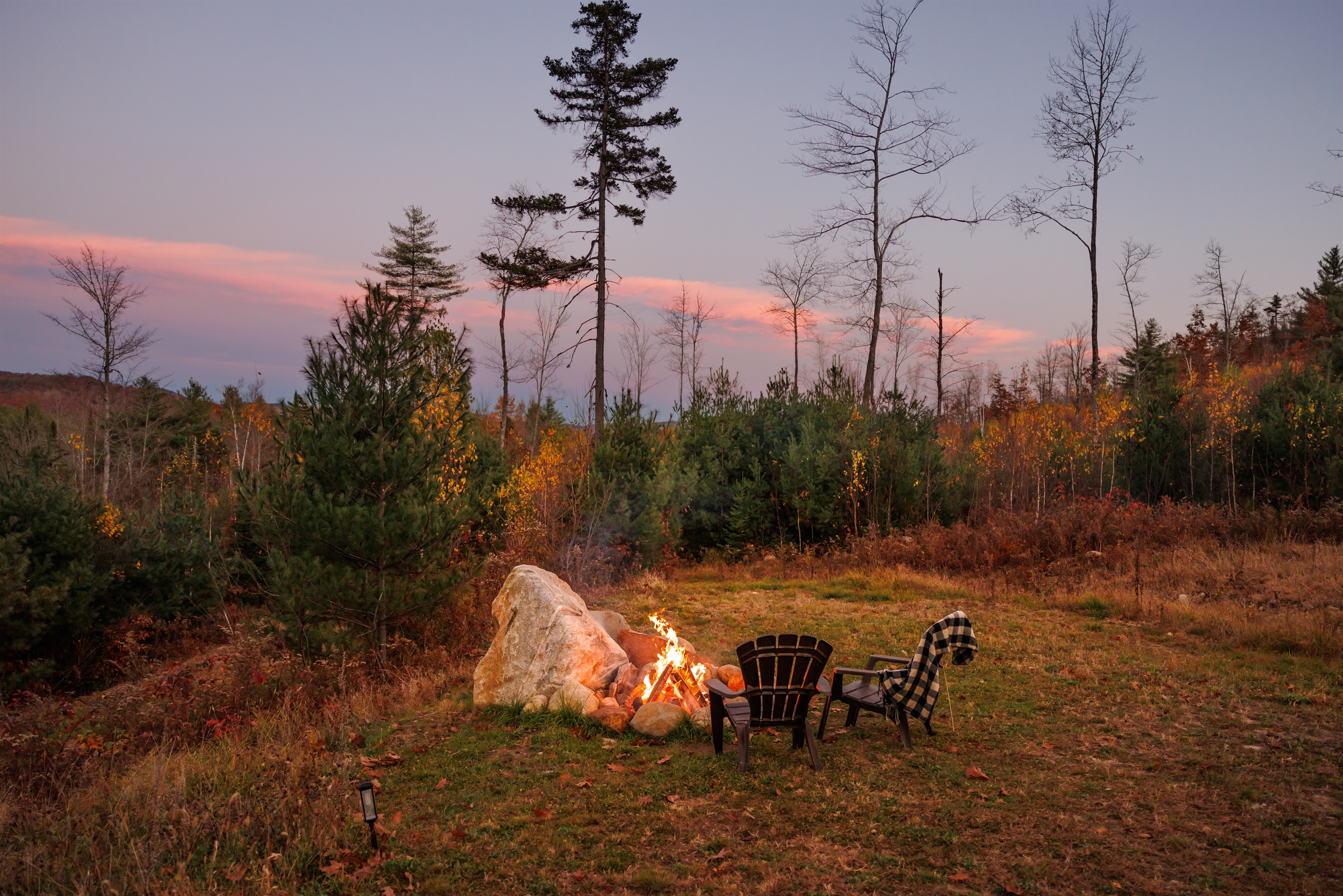 Open field and fire pit at sunset