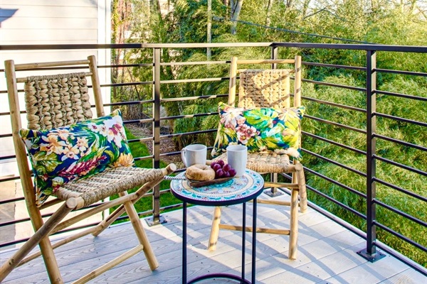 - Sip your morning coffee or wind down with wine in these woven rockers - Surrounded by bamboo greenery for peaceful, tropical energy - Colorful pillows & a cute bistro table set the scene for easy outdoor lounging
