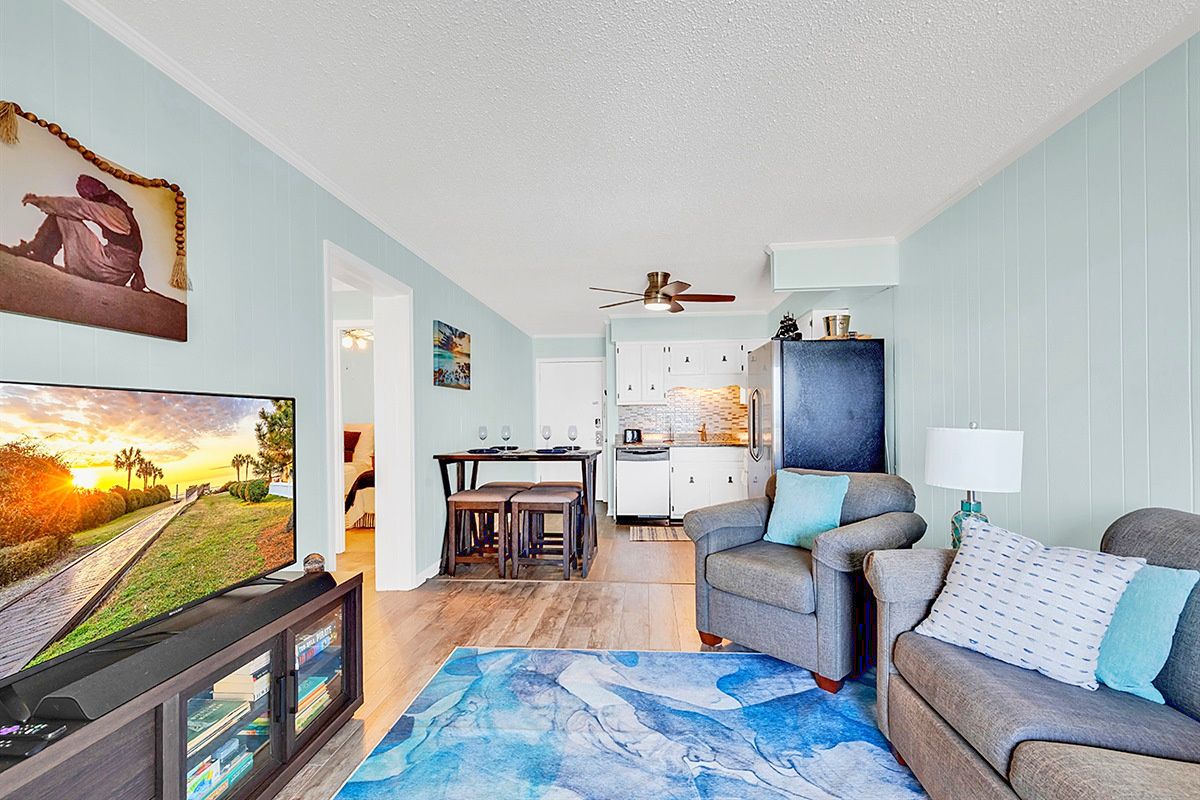 Living Room – Open floor plan with smart TV and dining nook