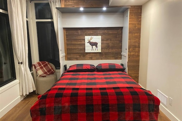 Bedroom 3 on lower level with Queen murphy bed laid out for sleeping.