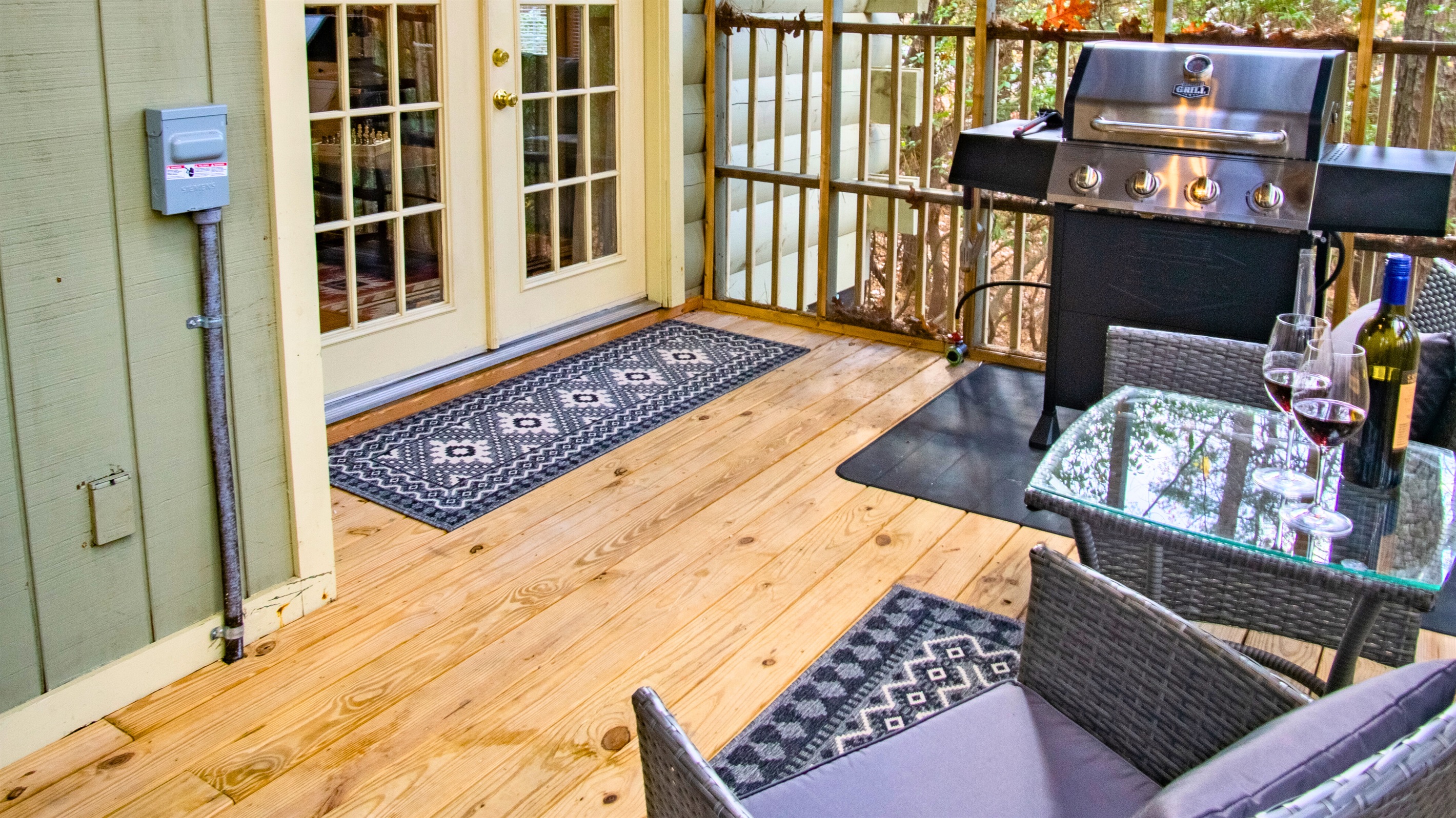 Outdoor grill station with seating and wine-ready deck — perfect for al fresco dining.