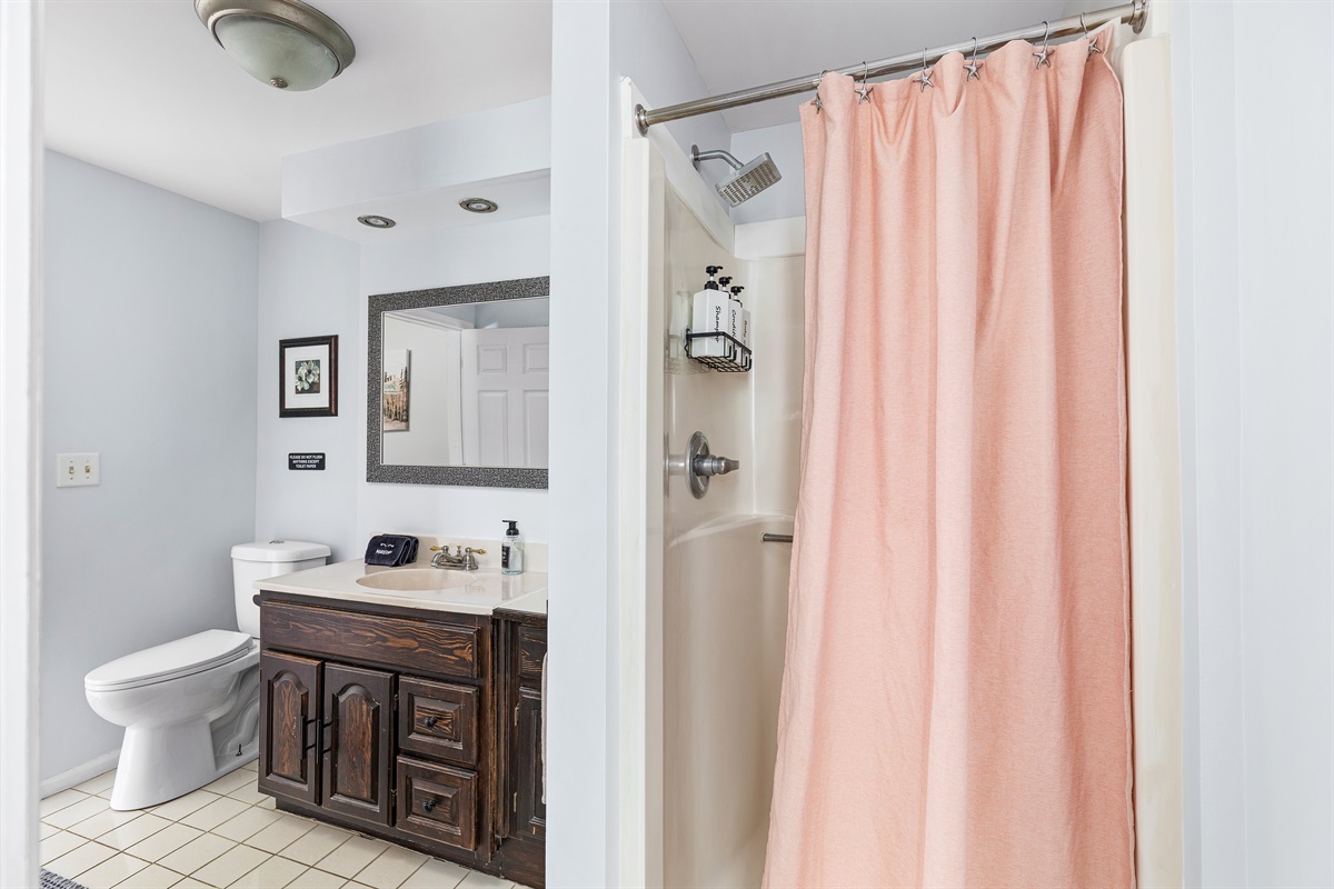 This convenient first floor bathroom with standing shower makes coming and going effortless after beach days.