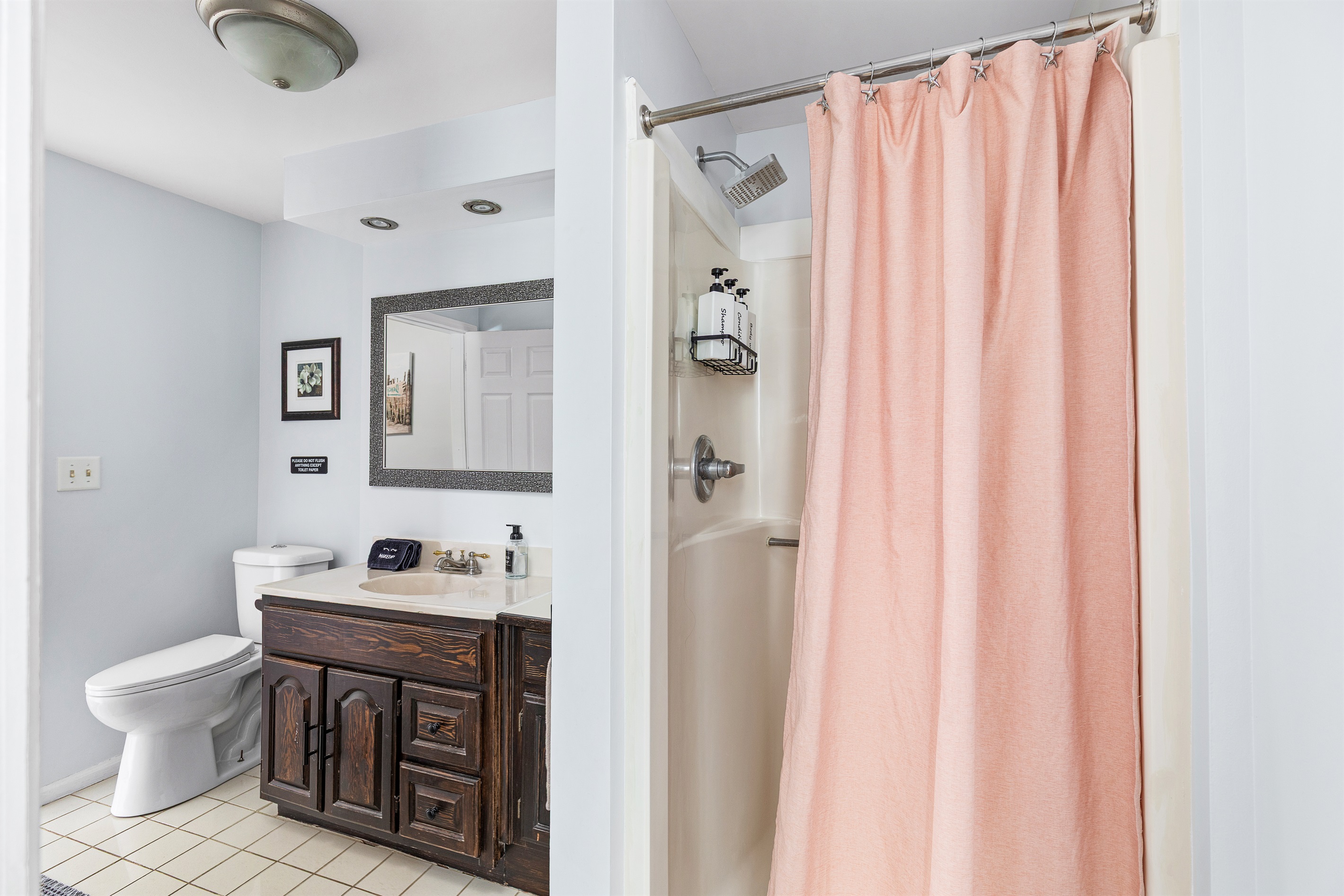 This convenient first floor bathroom with standing shower makes coming and going effortless after beach days.