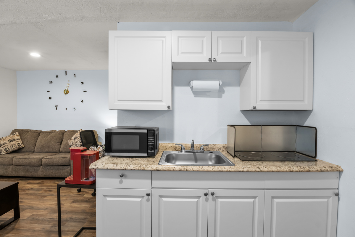 Kitchen stovetop burners & microwave.