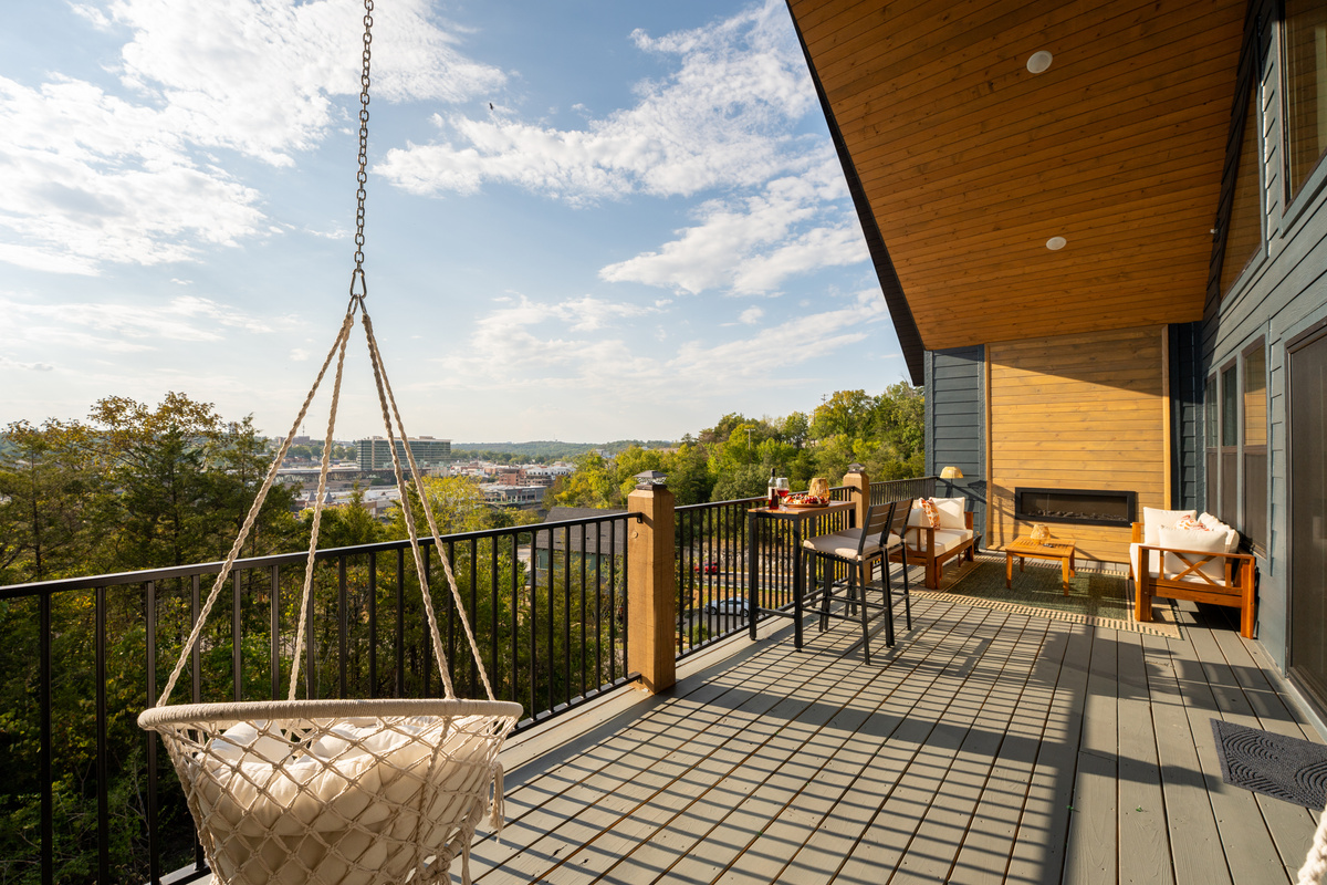 The expansive upper deck gives everyone room to spread out, with hanging chairs, outdoor dining, lounge seating, and sweeping Branson views.