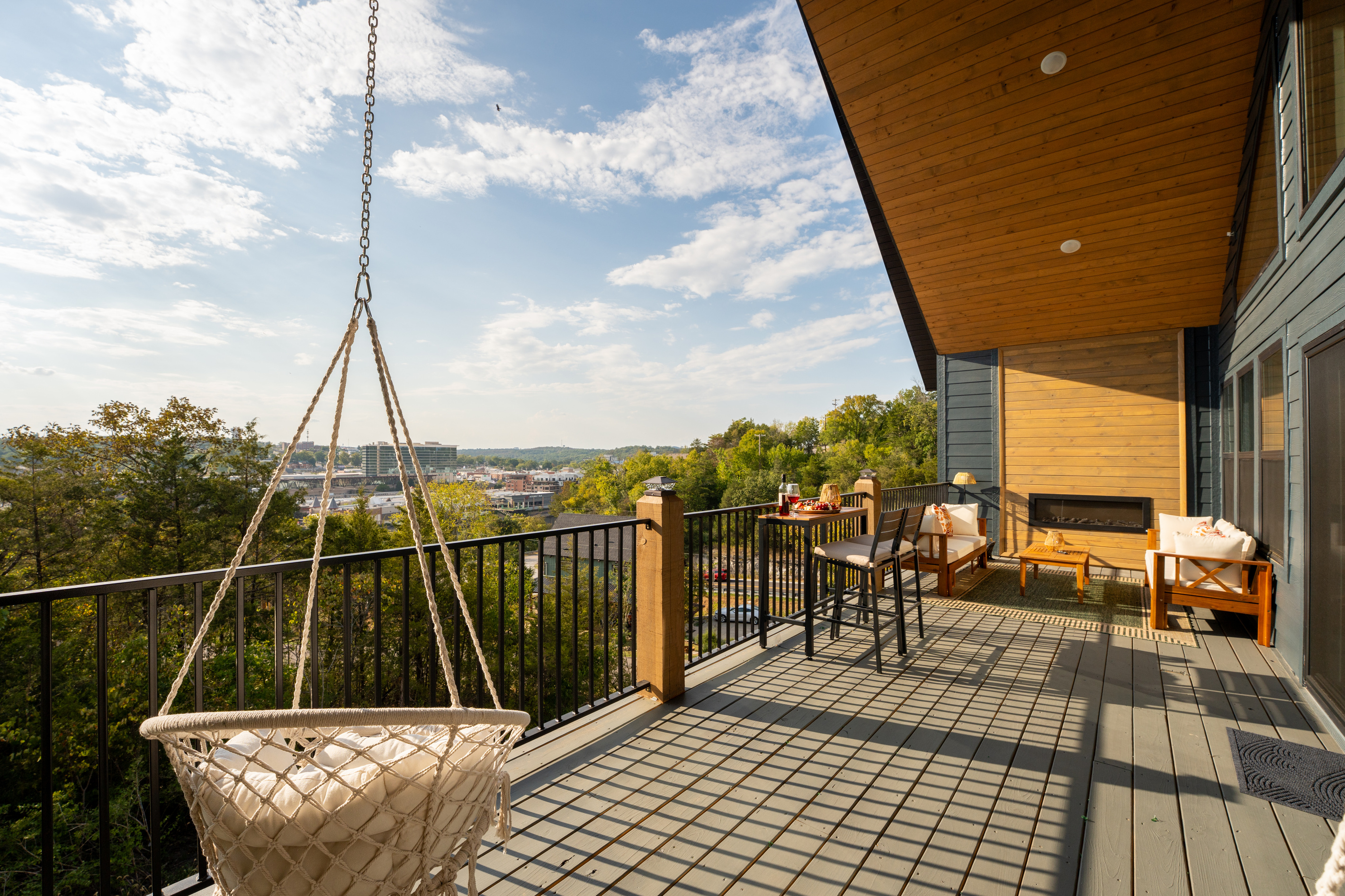 The expansive upper deck gives everyone room to spread out, with hanging chairs, outdoor dining, lounge seating, and sweeping Branson views.