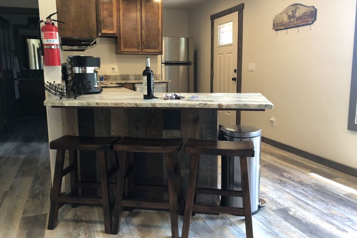 Bar seating. Coffee table pops up for additional dining space. 