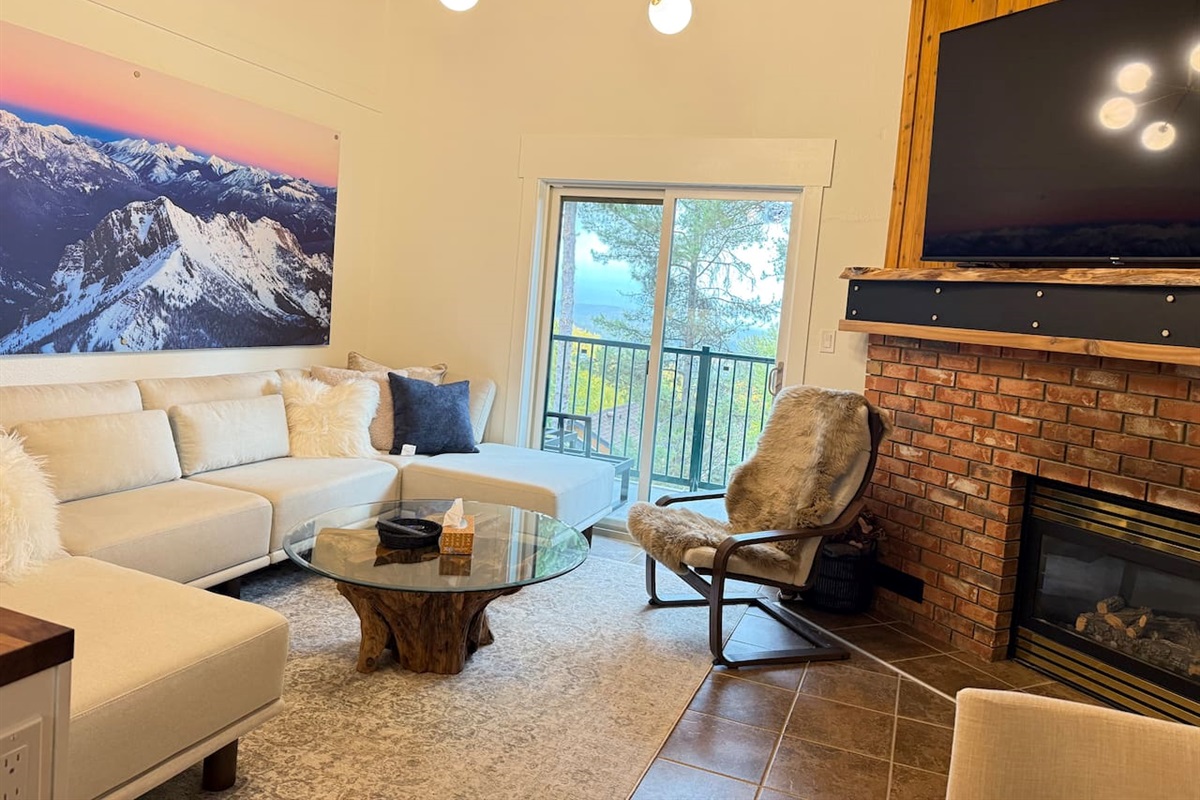 Balcony Access: The living room offers direct access to the private balcony, perfect for morning coffee while overlooking the stunning Rocky Mountains.