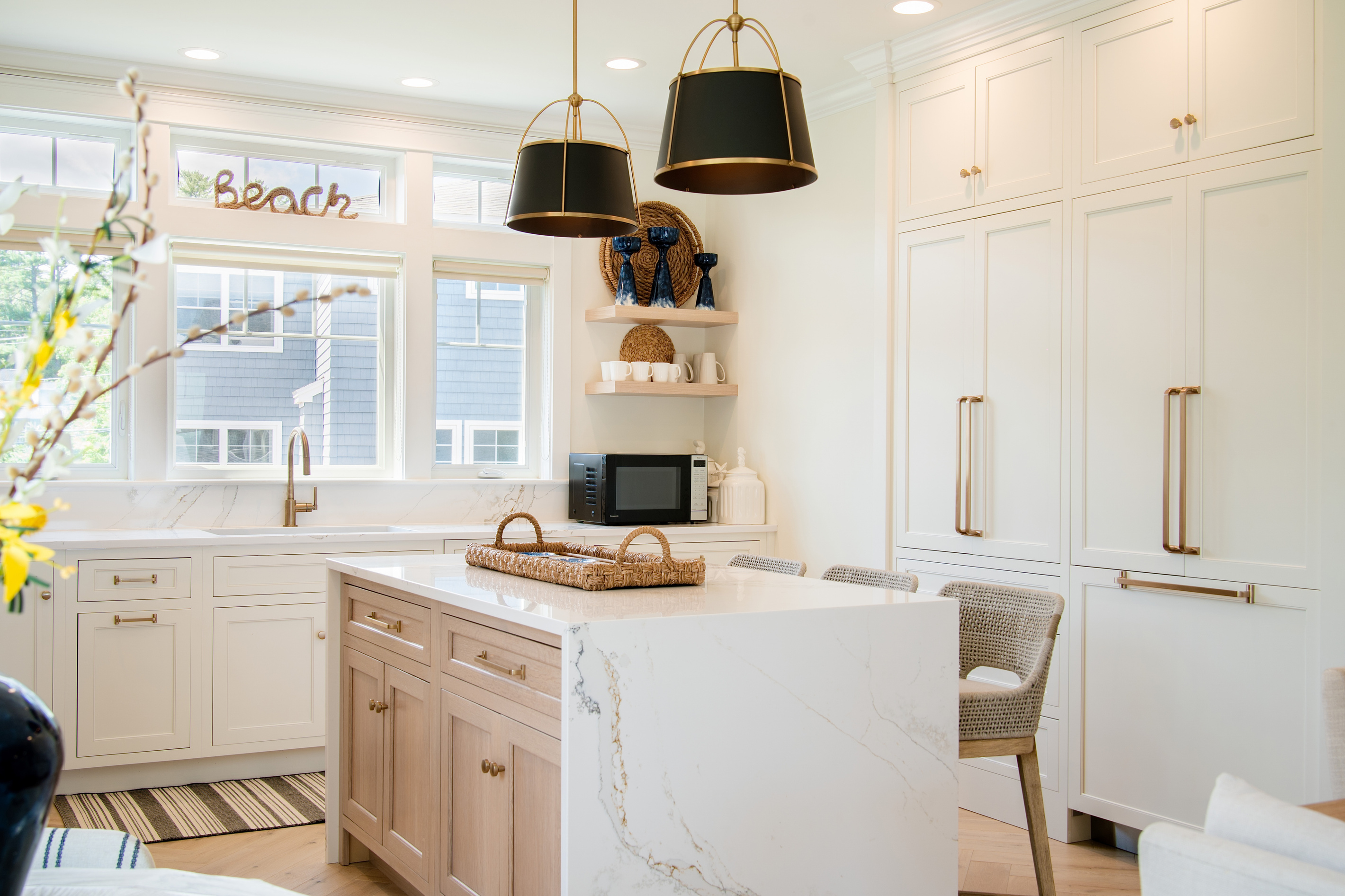 Clean coastal design meets everyday convenience in this spacious, light-filled kitchen.