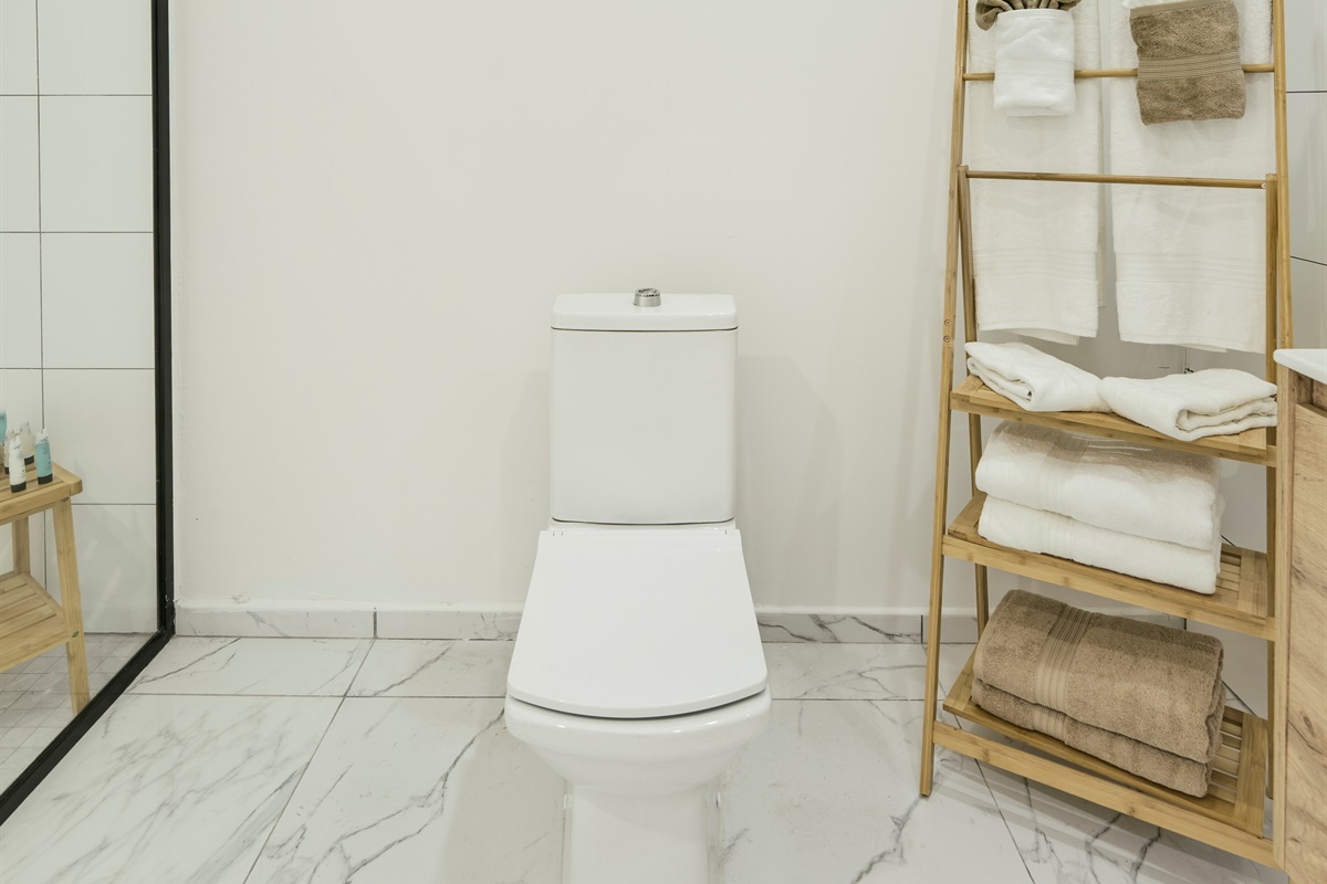 Bathroom with Modern Toilet & Woven Towel Storage Tower