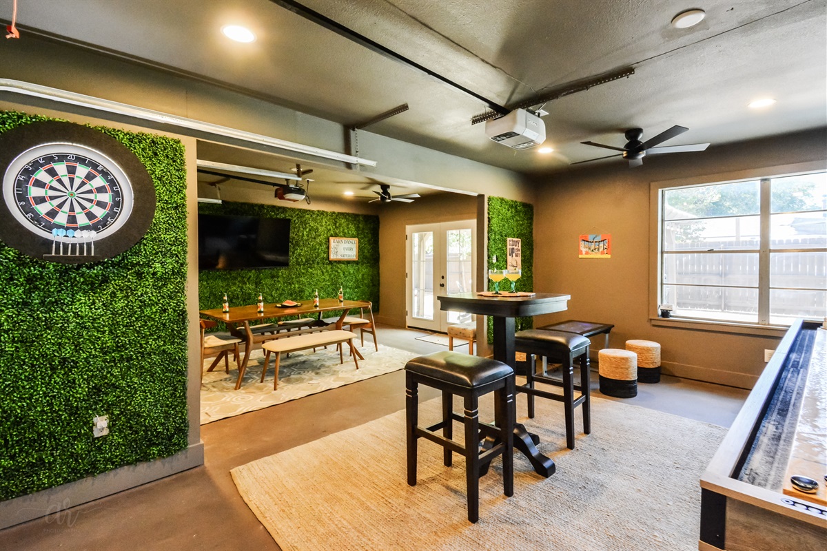 Epic Game Room Fun for All Ages → Enjoy shuffleboard, darts, Infinity Game Table & a big-screen TV for sports and movie nights! 
