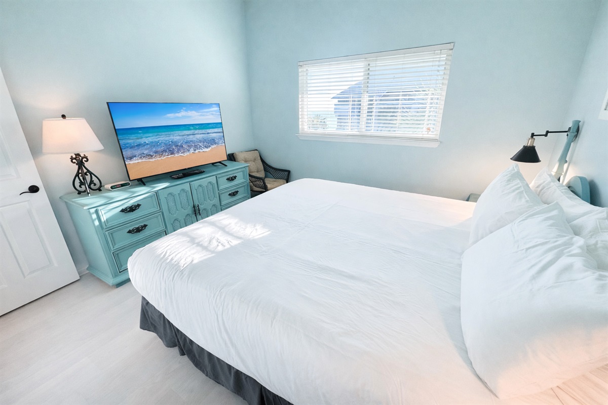 Spacious master bedroom with TV