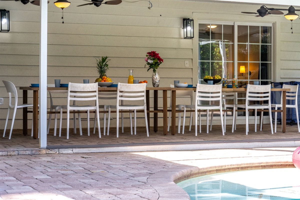 The covered patio opens to a serene pool area, ideal for al fresco dining and entertaining under the Florida sunshine.