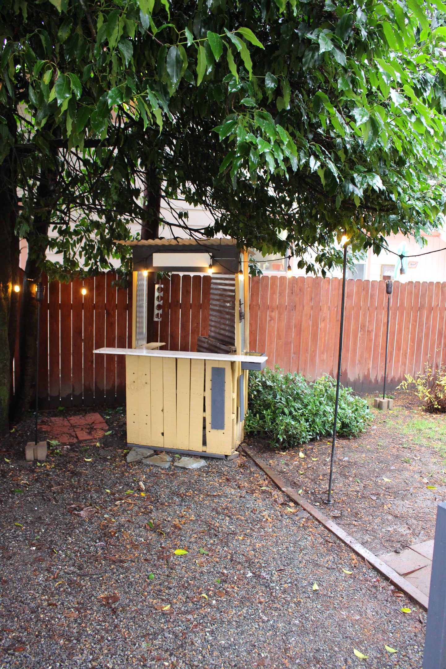 Outdoor entertaining area to enjoy during warmer months, with string lights overhead and plenty of seating seasonally