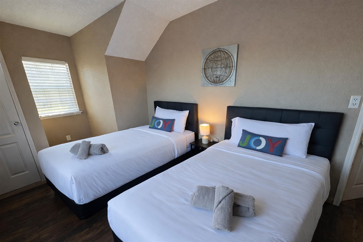 Twin bedroom with 2 separate beds — perfect for kids, friends, or flexible sleeping arrangements during family vacations.