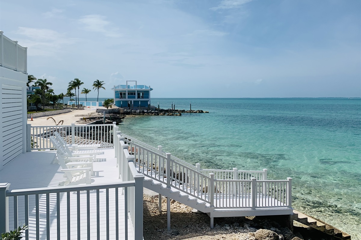 MERMAID COVE - The lower deck has two chaise lounges and two Adirondack chairs with tables, gas grill and water toys. Grab a paddle board and a kayak on the lower deck, stairs lead you directly into the Sea of Abaco.