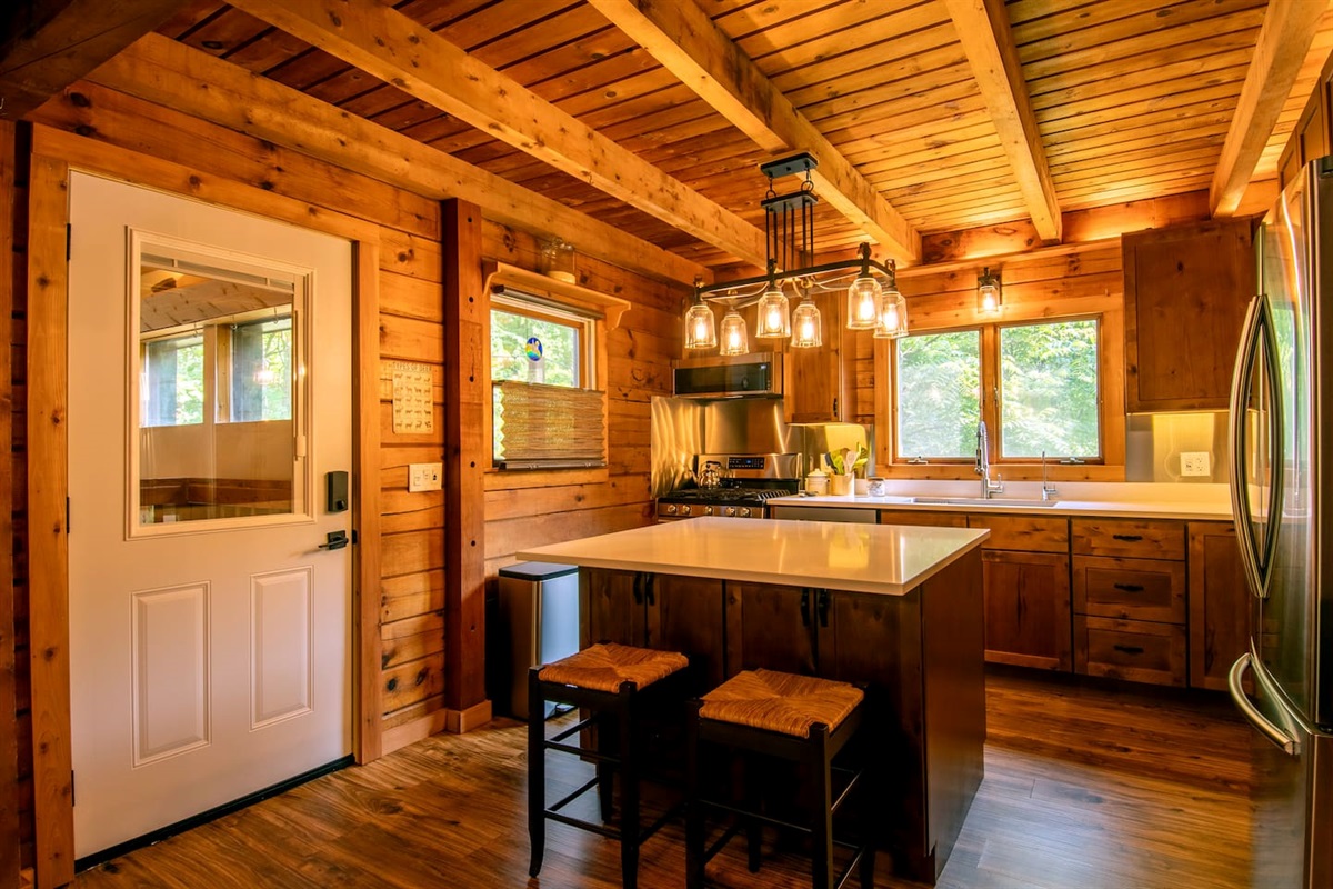 Breakfast bar and door to sunroom (shared space). Extra cabinet space for your things under the island.