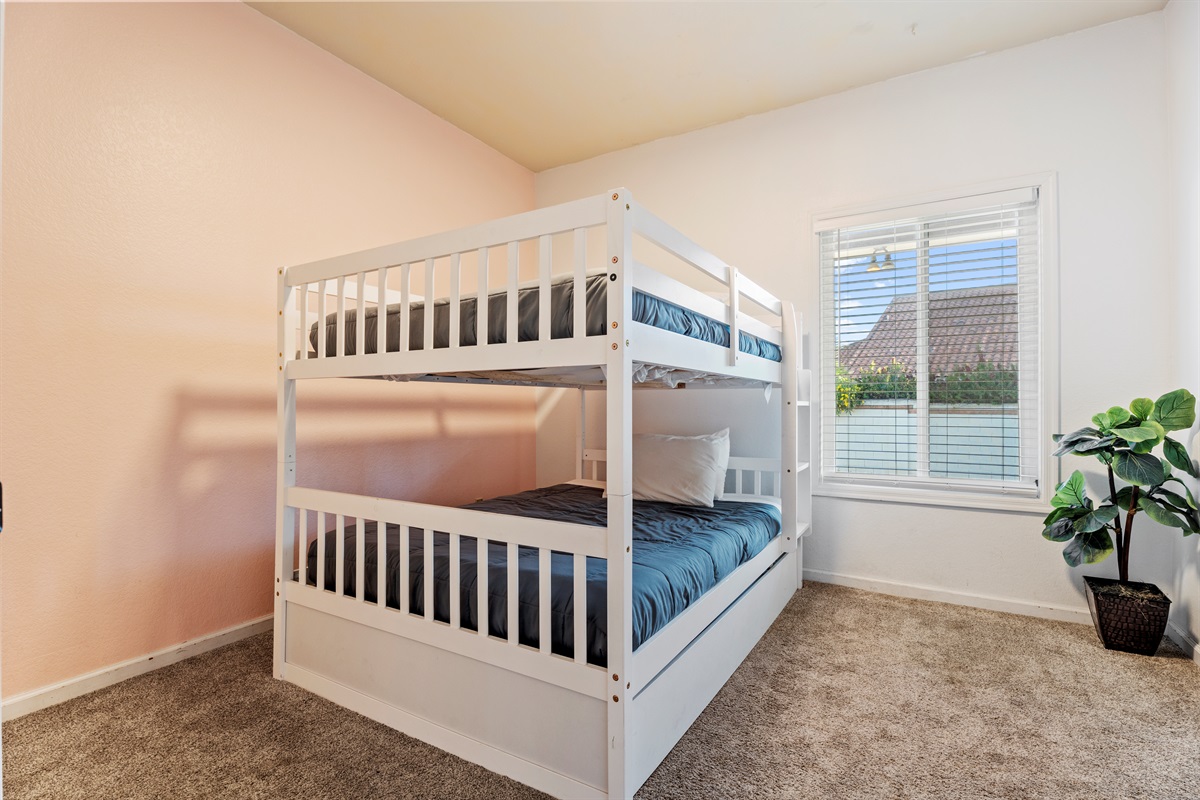 Designed with families in mind, this bright and cheerful bunk room offers cozy sleeping space and plenty of natural light.