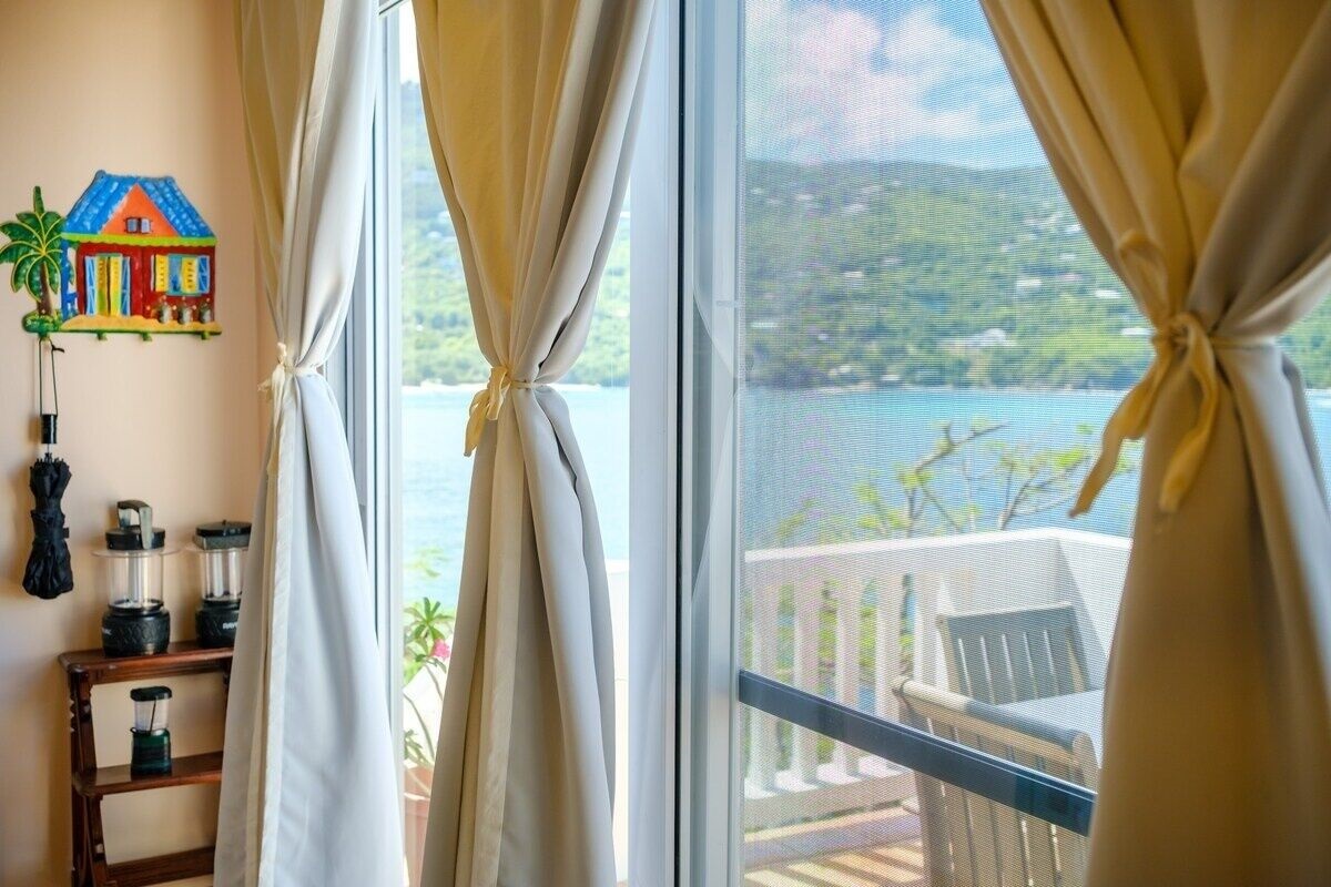 Sliding doors that leading out to another patio with a small dining table.