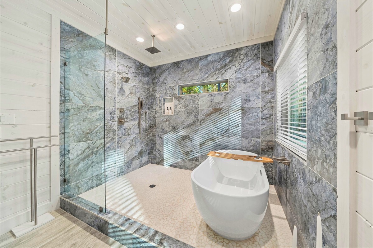 Bathroom with glass shower and elegant tile detail.